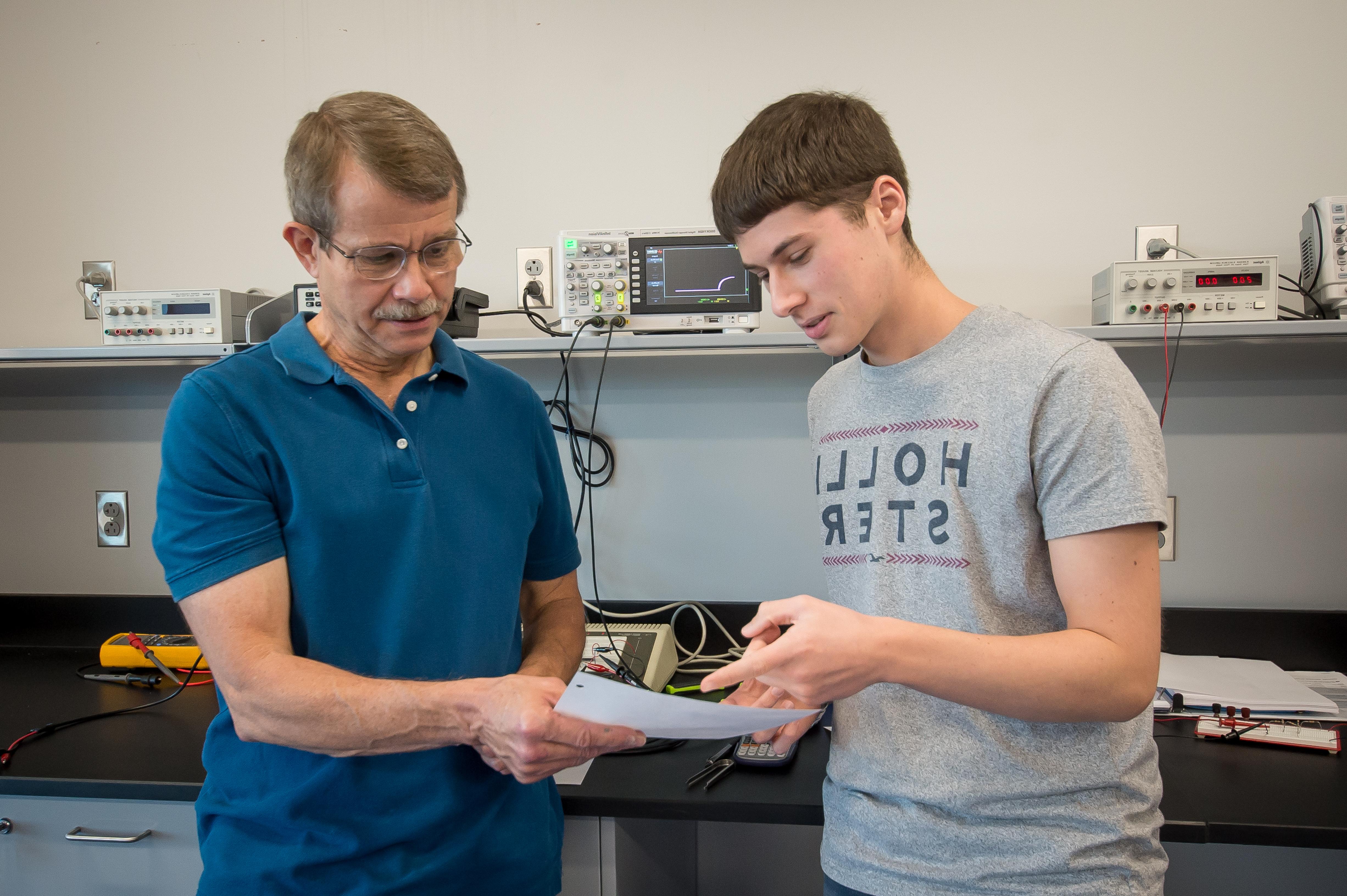 Engineering professor going over an assignment with his student